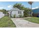 View of house with a grassy front yard and a concrete driveway with landscaping and palm trees at 1525 38Th N Ave, St Petersburg, FL 33704