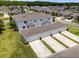 Aerial view of townhomes featuring three-car garages and well-manicured landscaping and large lawns at 15430 Caravan Ave, Odessa, FL 33556