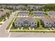 Aerial view of the townhome community, with parking areas and greenery surrounding the buildings at 15430 Caravan Ave, Odessa, FL 33556