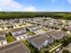Expansive aerial view of a townhome community with lush landscaping, ponds, and green spaces at 15430 Caravan Ave, Odessa, FL 33556