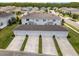 Aerial view of townhomes with long driveways and garages, complemented by green landscaping at 15430 Caravan Ave, Odessa, FL 33556