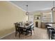 Cozy dining area with a wooden table, bench seating, and modern light fixture, adjacent to the kitchen at 15430 Caravan Ave, Odessa, FL 33556