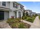 Attractive townhome with landscaping, stone pillars, dark shutters, and a welcoming front entrance at 15430 Caravan Ave, Odessa, FL 33556