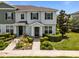 Charming townhome with a well-maintained lawn and inviting front entrance and exterior shutters at 15430 Caravan Ave, Odessa, FL 33556