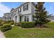 Attractive townhome with lush landscaping and a well-manicured lawn at 15430 Caravan Ave, Odessa, FL 33556