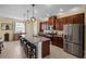 Spacious kitchen with stainless steel appliances, granite countertops, and a large center island with seating at 15430 Caravan Ave, Odessa, FL 33556