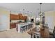 Open concept kitchen and dining area boasts a large island, stainless appliances, and stylish pendant lighting at 15430 Caravan Ave, Odessa, FL 33556