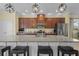 Kitchen island with granite countertop, pendant lighting, and seating for casual dining at 15430 Caravan Ave, Odessa, FL 33556