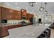 Modern kitchen features stainless steel appliances, granite countertops, and a large island with seating at 15430 Caravan Ave, Odessa, FL 33556