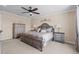 Serene main bedroom features a plush bed, elegant nightstands, and a decorative headboard with soft lighting at 15430 Caravan Ave, Odessa, FL 33556
