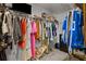 Well-organized walk-in closet featuring ample hanging space, shelving, and a television for added convenience at 15430 Caravan Ave, Odessa, FL 33556