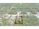 Aerial view of house with property line surrounded by pine trees at 16473 Scaup Duck Ave, Weeki Wachee, FL 34614