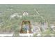 An aerial view of a property with a red outline, nestled among lush green trees at 16473 Scaup Duck Ave, Weeki Wachee, FL 34614