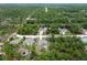 An aerial view shows a quiet neighborhood road winding through dense woods at 16473 Scaup Duck Ave, Weeki Wachee, FL 34614