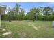Expansive backyard with mature trees and lush green lawn at 16473 Scaup Duck Ave, Weeki Wachee, FL 34614