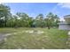 Wide shot of backyard, including a fire pit, storage shed, pool, and playground at 16473 Scaup Duck Ave, Weeki Wachee, FL 34614
