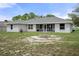 The backyard features an outdoor BBQ under a screened in patio and a quaint fire pit at 16473 Scaup Duck Ave, Weeki Wachee, FL 34614