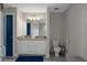 A spacious bathroom featuring a double vanity with granite countertops and a glass door shower at 16473 Scaup Duck Ave, Weeki Wachee, FL 34614