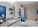 Well-lit bathroom featuring granite countertops and shower with blue accents at 16473 Scaup Duck Ave, Weeki Wachee, FL 34614