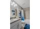 Well-lit bathroom featuring granite countertops and shower with blue accents at 16473 Scaup Duck Ave, Weeki Wachee, FL 34614