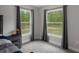 Bright bedroom with natural light from the two windows providing views of the beautiful outdoor greenery at 16473 Scaup Duck Ave, Weeki Wachee, FL 34614