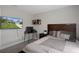 Inviting bedroom with wall-mounted TV and carpet at 16473 Scaup Duck Ave, Weeki Wachee, FL 34614