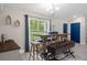 Cozy dining space with wood table, stylish bench, and ample natural light from large windows, perfect for casual dining at 16473 Scaup Duck Ave, Weeki Wachee, FL 34614