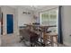 Charming dining area with a wooden table, bench seating, and natural light, ideal for enjoying meals at 16473 Scaup Duck Ave, Weeki Wachee, FL 34614
