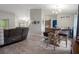 Open dining area with a stylish wooden table, comfortable seating, and view into the well-lit kitchen at 16473 Scaup Duck Ave, Weeki Wachee, FL 34614