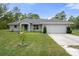 Charming single-story home boasts a well-maintained lawn and a two-car garage at 16473 Scaup Duck Ave, Weeki Wachee, FL 34614