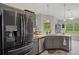 Spacious kitchen with stainless steel appliances, ample counter space, and great natural light, perfect for cooking at 16473 Scaup Duck Ave, Weeki Wachee, FL 34614