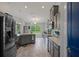 Open-concept kitchen featuring stainless steel appliances, ample counter space, and a view into the bright outdoors at 16473 Scaup Duck Ave, Weeki Wachee, FL 34614