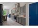 Modern kitchen with sleek gray cabinets, stainless steel appliances, and bright lighting, perfect for cooking and entertaining at 16473 Scaup Duck Ave, Weeki Wachee, FL 34614