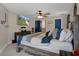 A cozy main bedroom features a ceiling fan and a TV across from the bed for relaxing entertainment at 16473 Scaup Duck Ave, Weeki Wachee, FL 34614