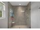 Walk-in shower with tile surround and a window providing natural light at 16473 Scaup Duck Ave, Weeki Wachee, FL 34614