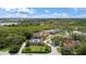 An aerial view showcases this home with mature trees and landscaping and nearby waterway access at 1721 Allens Creek Dr, Clearwater, FL 33764