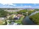 Stunning waterfront property with lush landscaping, private dock, and serene water views, showcasing luxury living at its finest at 1721 Allens Creek Dr, Clearwater, FL 33764
