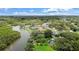 Picturesque waterfront home nestled amongst lush greenery with private dock and serene water views at 1721 Allens Creek Dr, Clearwater, FL 33764