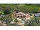 Aerial view of the property showing the beautiful landscaping, large home and surrounding foliage at 1721 Allens Creek Dr, Clearwater, FL 33764