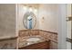 Bathroom vanity with granite counters, a stylish round mirror, and elegant fixtures for a touch of sophistication at 1721 Allens Creek Dr, Clearwater, FL 33764