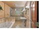 Bathroom featuring a walk-in shower, soaking tub, and a pedestal sink at 1721 Allens Creek Dr, Clearwater, FL 33764