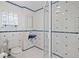 Unique bathroom features blue accents, glass block window, and walk-in shower at 1721 Allens Creek Dr, Clearwater, FL 33764