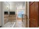 Elegant bathroom boasts a tub, glass shower, neutral tile, and intricate mosaic accents for a luxurious feel at 1721 Allens Creek Dr, Clearwater, FL 33764