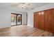 Bright bedroom features hardwood floors, ceiling fan, patio access and a large closet at 1721 Allens Creek Dr, Clearwater, FL 33764
