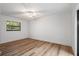 Minimalist bedroom with luxury vinyl flooring and a bright, airy atmosphere at 1721 Allens Creek Dr, Clearwater, FL 33764