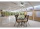 Bright dining room with a glass table, four chairs, marble tile floors, and a beautiful water view at 1721 Allens Creek Dr, Clearwater, FL 33764