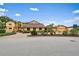 Exterior elevation showcases this home with a brick driveway, mature trees, and lush landscaping at 1721 Allens Creek Dr, Clearwater, FL 33764