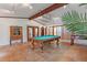 Spacious game room featuring a pool table, tile flooring and natural light at 1721 Allens Creek Dr, Clearwater, FL 33764