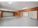 Spacious garage featuring wood paneled walls, painted flooring, overhead lighting, and tool storage at 1721 Allens Creek Dr, Clearwater, FL 33764