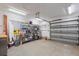 Well-lit garage featuring open shelving for storage and a gray garage door at 1721 Allens Creek Dr, Clearwater, FL 33764